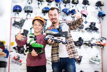 Ordinary father and boy boasting roller-skates
