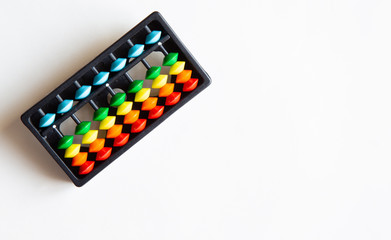 Abacus with colored beads, toy to learn counting, text and copy space