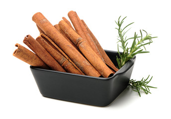  Cinnamon and rosemary on a white background