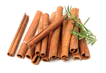  Cinnamon and rosemary on a white background