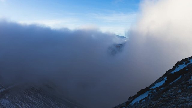 Time lapse of snow mountain range summit in the sea of clouds under the blue sky 4k landscape of snowy mountain  