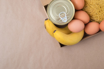 Volunteers with donation box with foodstuffs.