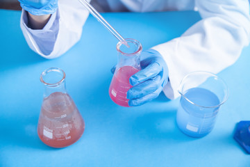 Girl working with flask in a laboratory.