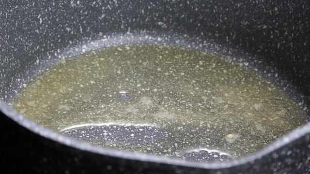 Adding Cumin seeds in Desi ghee clarified butter.
