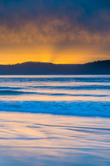 Cloud Covered Sunrise Seascape with Sun Rays