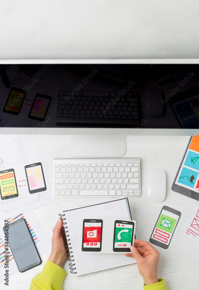 Poster web designer mobile phone application developer. top view of the desktop of the creator of the sketc