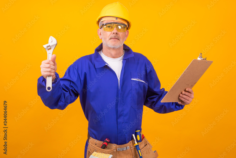 Wall mural construction worker or professional isolated on color background with tools