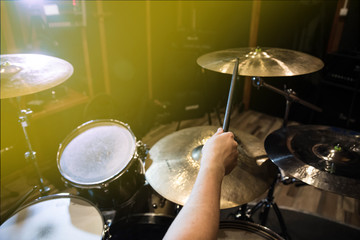 
Professional drum set closeup. Man drummer with drumsticks playing drums and cymbals, on the live...