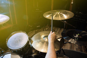 
Professional drum set closeup. Man drummer with drumsticks playing drums and cymbals, on the live...
