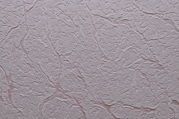 The texture of the pink surface of the wall made using Venetian plaster and wallpaper
