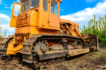 Industrial building construction site bulldozer leveling and moving soil during highway building