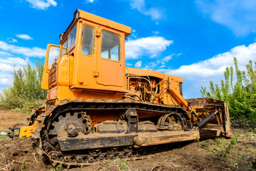 Industrial building construction site bulldozer leveling and moving soil during highway building