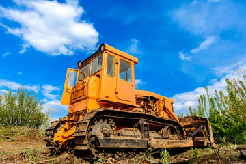 Industrial building construction site bulldozer leveling and moving soil during highway building