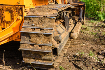 Industrial building construction site bulldozer leveling and moving soil during highway building