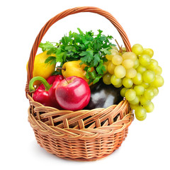 Vegetables and fruits in a basket isolated on white background.