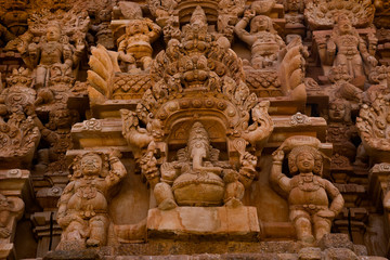 Fototapeta na wymiar A closeup view of the statues in temple tower of big temple in Tamil Nadu