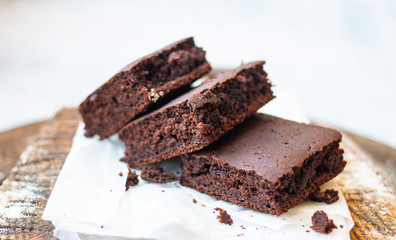 Baked chocolate vegan dessert. Homemade brownie cake with  sweet cream spread. 