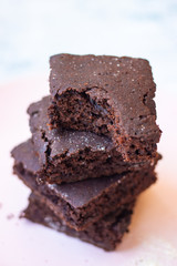 Baked chocolate vegan dessert. Homemade brownie cake with  sweet cream spread. 