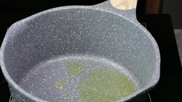 Adding Asafoetida to Clarified butter.