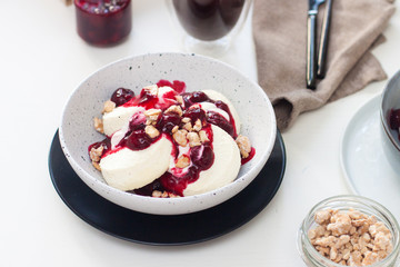Cottage cheese pancakes with berry sauce and nuts. Healthy breakfast concept.