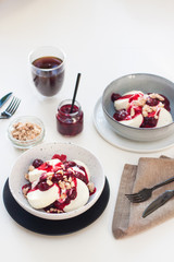 Cottage cheese pancakes with berry sauce and nuts. Healthy breakfast concept.