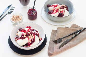 Cottage cheese pancakes with berry sauce and nuts. Healthy breakfast concept.