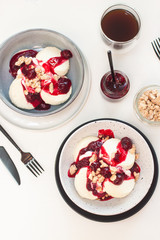 Cottage cheese pancakes with berry sauce and nuts. Healthy breakfast concept.