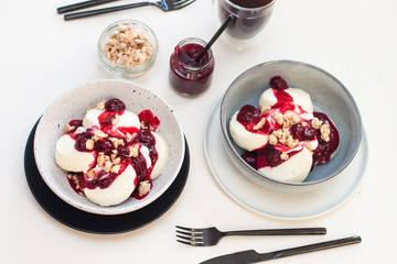 Cottage cheese pancakes with berry sauce and nuts. Healthy breakfast concept.