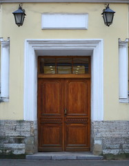 Fototapeta na wymiar Big old closed light wooden door
