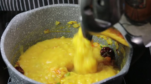 Cooking Pulses or lentils for Daal Tadka, an Indian lentils soup dish.