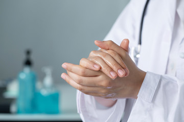 Closeup doctor hands washing  with hand sanitizer gel.Coronavirus hand washing for clean hands hygiene Covid19 spread prevention
