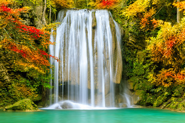 Colorful majestic waterfall in national park forest during autumn