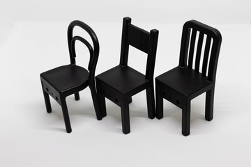 Obraz premium Mini toy chairs isolated on white background. Chair design, modern style