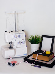 
seamstress workplace with sewing machine, fabric cut, pattern and details