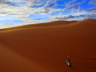 sandy desert. a man walks along a sandy desert