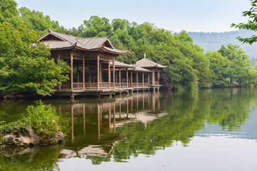 Fototapeta na wymiar Wooden platform and walking path in West Lake gardens in Hangzhou, China