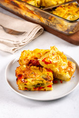 Vegetable clafoutis, savory pie with bell peppers, peas, onions and tomatoes.