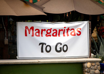 Sign at restaurant offering Margaritias To Go