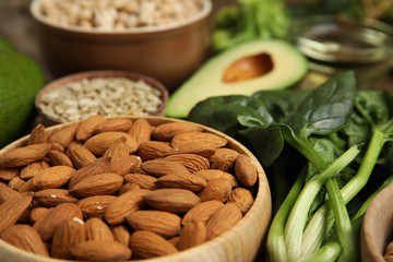 Different products rich in vitamin E on table, closeup