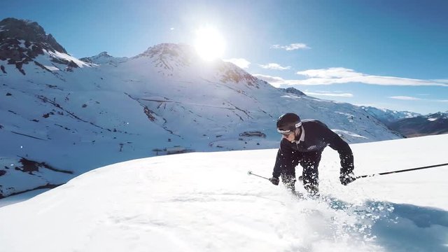 Following View Of A Young Man Skier Skiing Doing A Jump Trick In A French Ski Resort During Winter