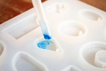 Pouring blue clear glitter resin to resin mold , process of prepare for make an accessories