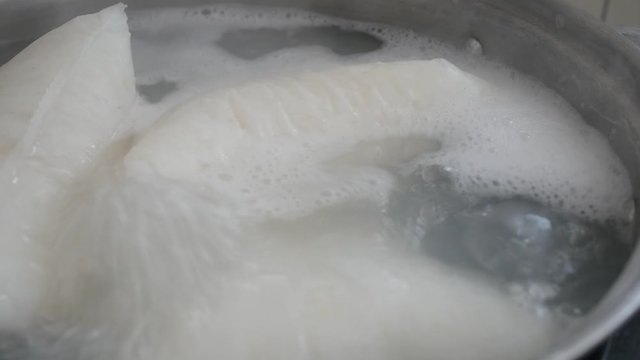 Nasi Impit or pressed rice in the plastic pack is boiled using hot water in a pan. Nasi Impit is usually cooked by Malay Muslims during Eid Celebration in Malaysia.