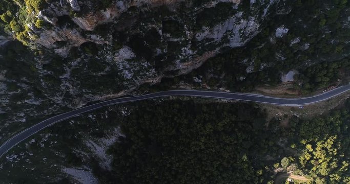 High aerial flyover  empty rural road in green valley , Kadisha valley Lebanon sunset