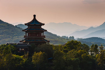 Fototapeta premium Chinese pagoda on an island, in the middle of water and mountains