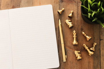 top view image of open notebook with blank pages on wooden table. ready for adding text or mockup