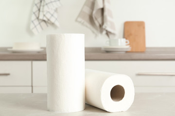 Rolls of paper towels on light grey marble table in kitchen