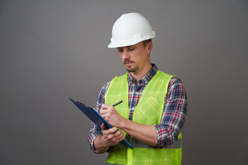 Worker man wearing protective hard hat and reflective vest.