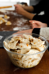 hot food cooked at home in the kitchen,national dish,quick cooking dumplings,full pan of boiled dumplings,pulp-dumplings stand in a transparent bowl on the kitchen table