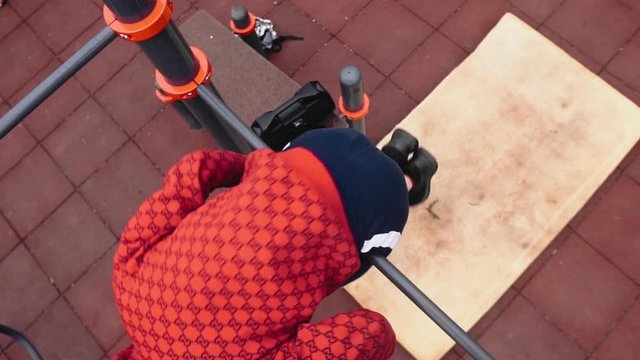 The guy does a rollover on the horizontal bar and jumps to the ground