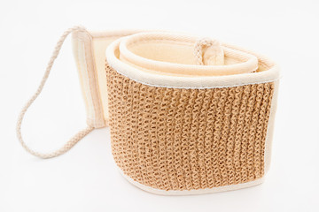 Natural eco-friendly jute washcloth on a white background. Brown body washcloth. Closeup
